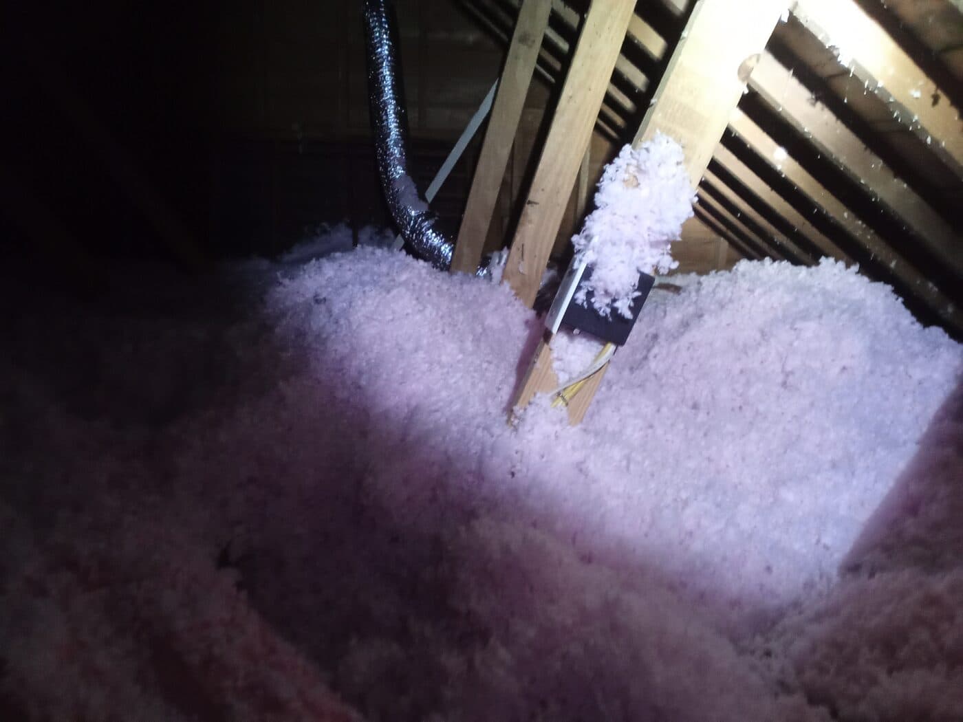 Fresh blown-in insulation filling an attic